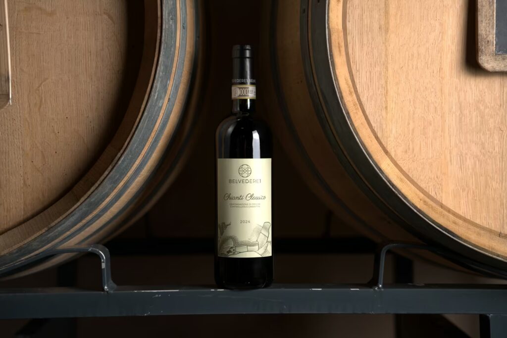 Belvedere1 Chianti Classico wine bottle displayed between oak barrels in the cellar
