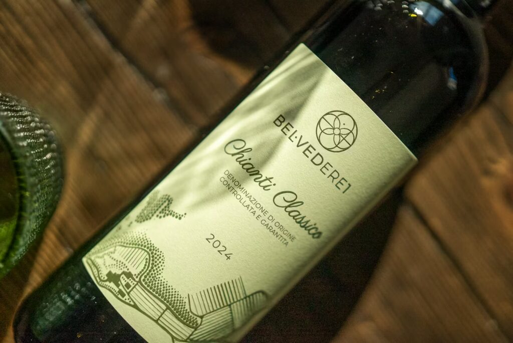 Close-up of eco-friendly printing wine labels on a Belvedere1 Chianti Classico dark glass wine bottle